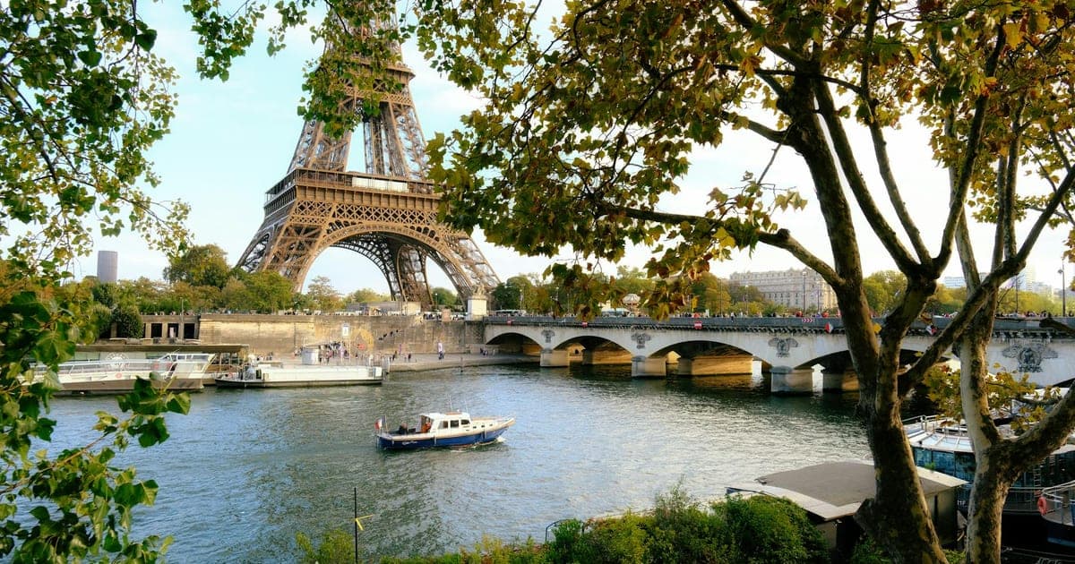 View of the Eiffel Tower from Trocadéro at sunset with Parisian architecture