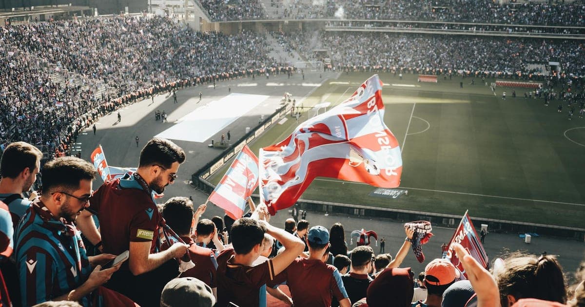 Aerial view of a packed football stadium during a World Cup match with city skyline