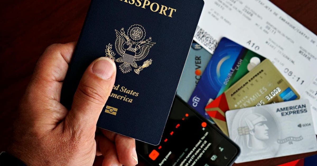 Passport, boarding pass, and travel essentials laid out on a wooden table before an international trip