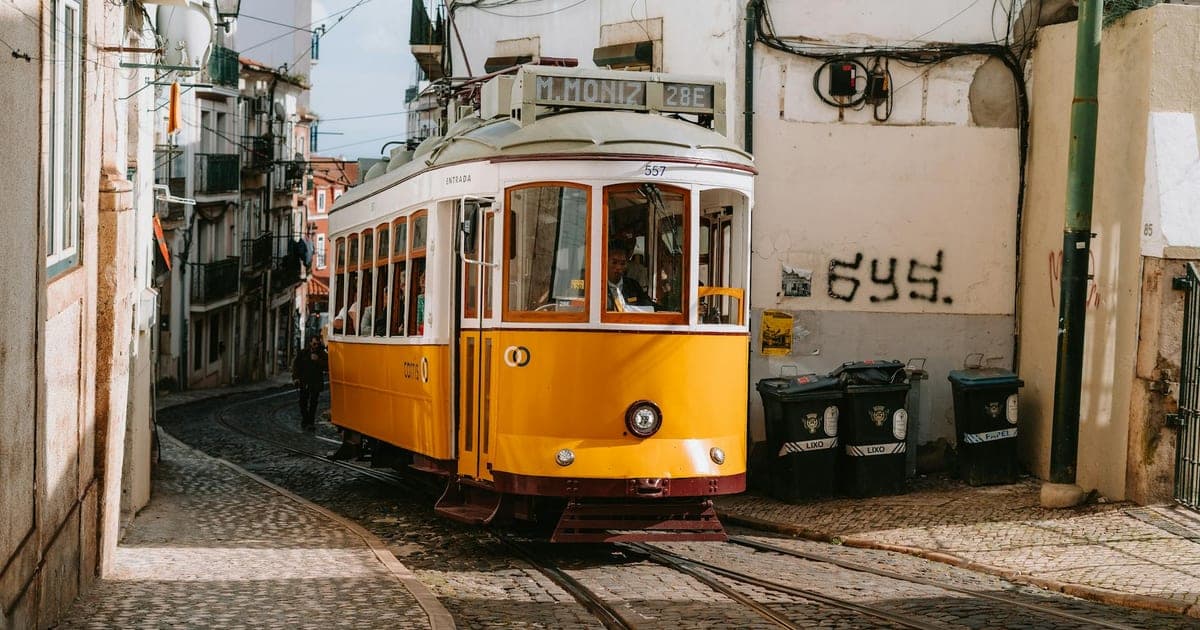 Colorful tram 28 winding through Alfama's narrow streets in Lisbon