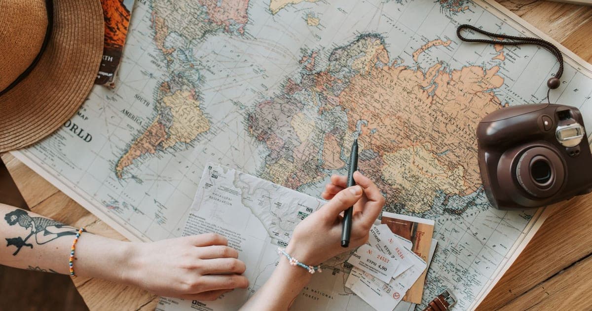 Data visualization of 2026 travel planning trends on a laptop and phone