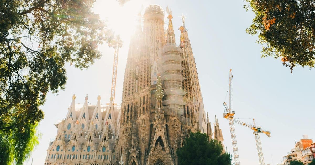 Split image comparing the Eiffel Tower in Paris and the Sagrada Familia in Barcelona