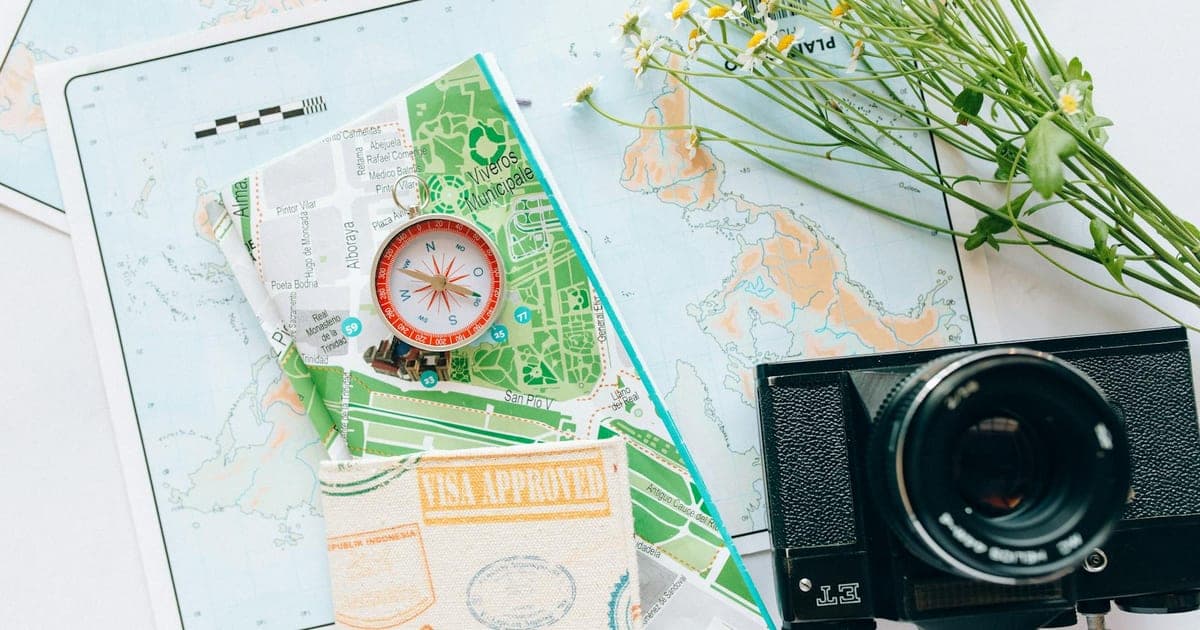 World passports fanned out on a map next to a globe and boarding pass, representing the 2026 Passport Power Index