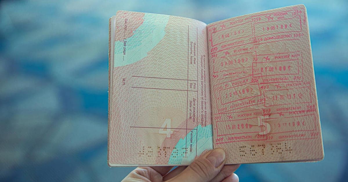 US passport on a world map with boarding passes and travel stamps
